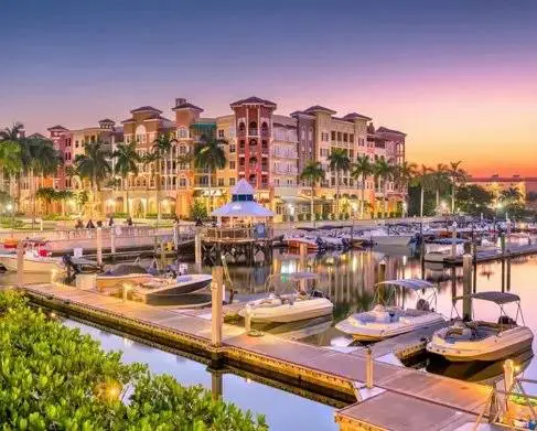 A marina with boats docked in it at night.