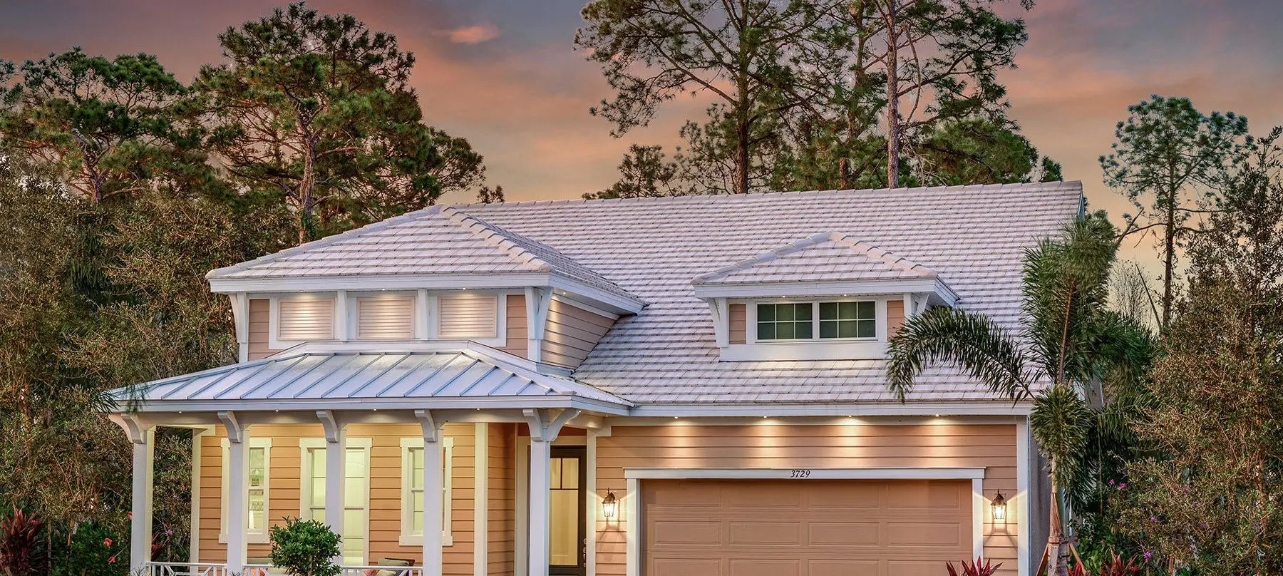 A house with a garage and trees in the background