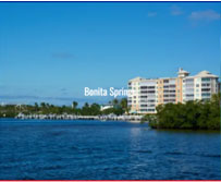 A large body of water with buildings in the background.