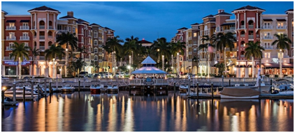 A marina with boats and lights at night.