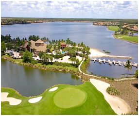 A golf course with lots of trees and water.