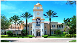 A large building with palm trees in front of it.