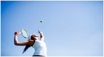 A woman is playing tennis on the court