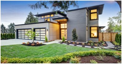 A modern home with a large lawn and garden.