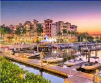 A marina with boats docked in it at sunset.