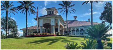 A large building with palm trees in the background.